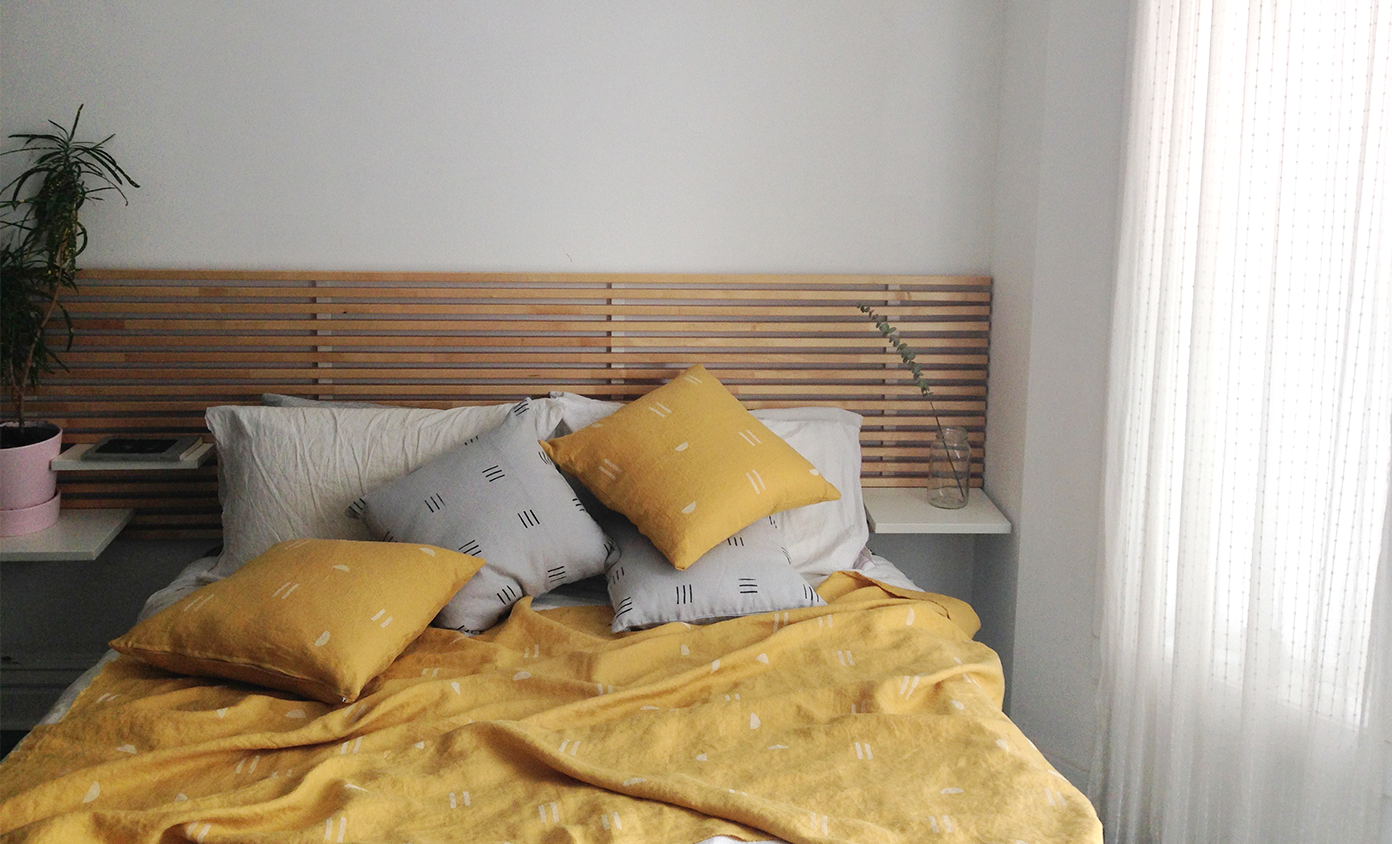 image of bed with throw and pillows